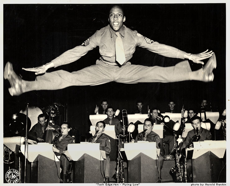 Dancer Tuck Edgerton leaping far above the stage.
